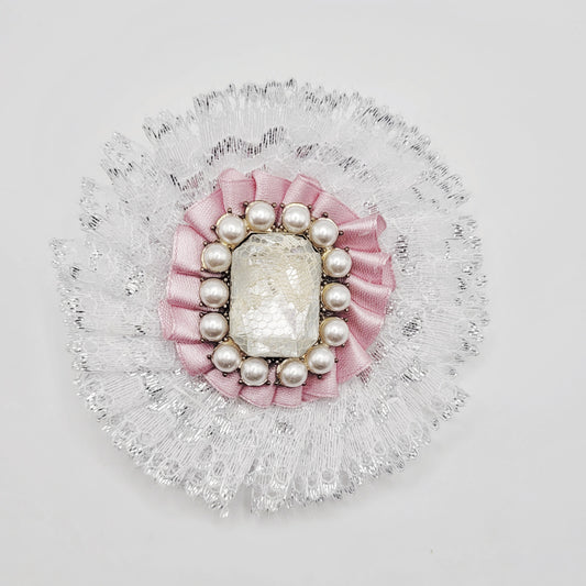 White and pink lolita brooch with shiny gem insert encrusted with pearls.